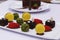 Assorted french pastries in a platter as petit four with macaroons, chocolate cake, pistachio balls etc