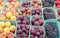 Assorted fruit at a Farmer`s Market Stall including, ripe peaches, purple plums, and grapes