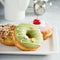 Assorted glazed fried donuts on a plate