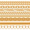 Assorted golden chains on white