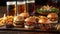 Assorted gourmet burgers and fries with cold craft beers on a wooden table