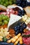 Assorted gourmet cheeses and meats, vertical closeup