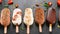 Assorted gourmet ice cream popsicles with toppings on black background