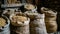 Assorted grains in burlap sacks at rustic warehouse