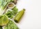 Assorted green toned raw organic vegetables on white background. Avocado, cabbage, cauliflower and cucumber with trimmed and mung