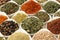 Assorted herbs and spices displayed in spoons, close up view for culinary enthusiasts