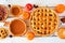 Assorted homemade autumn pies. Table scene on a white wood background.