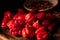 Assorted hot chilli pepper and blurred crushed peppers closeup on dark moody background
