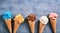 Assorted ice cream flavors in cones in a banner