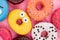 Assorted iced donuts background.