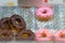 Assorted iced donuts on display in a bakery