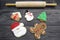 Assorted Iced Gingerbread Cookies with Rolling Pin on Wood