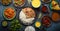 Assorted Indian ethnic food buffet on rustic concrete table from above