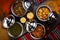 Assorted indian food with alu mutter, bhindi, keema, palak, saag and bhutta served in dish isolated on table top view of arabic