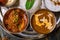 Assorted indian food set on wooden background. Dishes and appetisers of indeed cuisine, rice, lentils, paneer, samosa, spices, mas