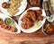 Assorted indian food on wooden background. Tandoori chicken,paneer tikka,kulcha, mutton seekh and chicken gravy.. kebab, Dishes