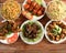 Assorted indian food on wooden background. Veg ball manchurian,chilli paneer,paneer manchurian,hakka noodles, vegfried rice and