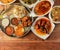 Assorted indian foods pepper chicken gravy,chicken masala and nonveg thali on wooden background. Dishes and appetizers of indian