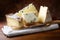 Assorted Italian cheeses with cutting board and knife in rustic setting