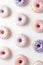 Assorted lavender and pink frosted donuts on a white background. Ideal for confectionery. AI Generated