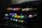 assorted markers arranged in sleek black pouch, tools for drawing and sketching