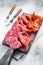 Assorted meat appetizers - salami, jamon, choriso sausages. White background. Top view