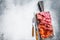 Assorted meat appetizers - salami, jamon, choriso sausages. White background. Top view. Copy space