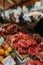 Assorted meat cuts on wooden tray in butcher shop with empty price tags for customization