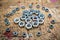 Assorted metal hex nuts shaping a circle on  wooden workbench stained grunge textured surface