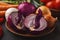 Assorted onions in a bowl on wooden background