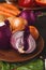 Assorted onions in a bowl on wooden background