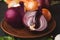 Assorted onions in a bowl on wooden background