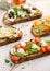 Assorted  open faced sandwiches, Open avocado sandwiches made of  slices of sourdough bread with  various toppings