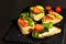 Assorted open sandwiches with salted salmon, cream cheese, salad leaves and cucumber. Seafood