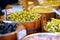 Assorted organic pickled olives, garlic, hot peppers, capers and sundried tomatos sold on a marketplace in Vilnius, Lithuania