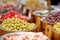 Assorted organic pickled olives, garlic, hot peppers, capers and sundried tomatos sold on a marketplace in Vilnius, Lithuania,