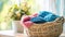 Assorted pastel color clothes neatly arranged in a wicker basket on a table