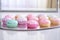 assorted pastel-colored cupcakes on a mirror reflective table