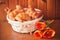 Assorted pastry in basket and tulip flowers.