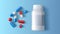 Assorted pharmaceutical medicine pills, tablets and capsules on blue background