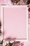 Assorted pink flower and white frame border on pink background, flat lay