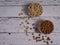 Assorted pistachio nuts, cashews, almonds and hazelnuts in two bowls on a white wooden table top view with copy space