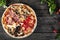 Assorted Pizza with bacon, mushrooms, peppers and olives on the