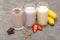 Assorted protein cocktails. Strawberry, banana and chocolate protein shakes. Sports nutrition and healthy lifestyle concept.