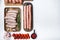 Assorted raw homemade sausages, flat lay with space for text, on white background