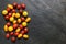 Assorted red, dark, yellow and orange small cherry tomatoes