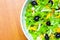 Assorted salad of green leaf lettuce with squid and black olives