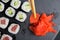 Assorted salmon and cucumber rolls, on a black table and pickled ginger