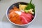 Assorted Sashimi rice, salmon and egg rolls.