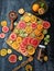 Assorted sliced citrus fruits on a wooden cutting board. Mixed tropical fruits lime, lemon, orange